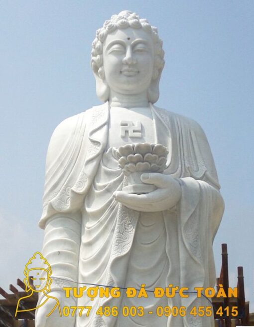 Tượng Phật A Di Đà đá nguyên khối màu trắng cầm bông hoa.