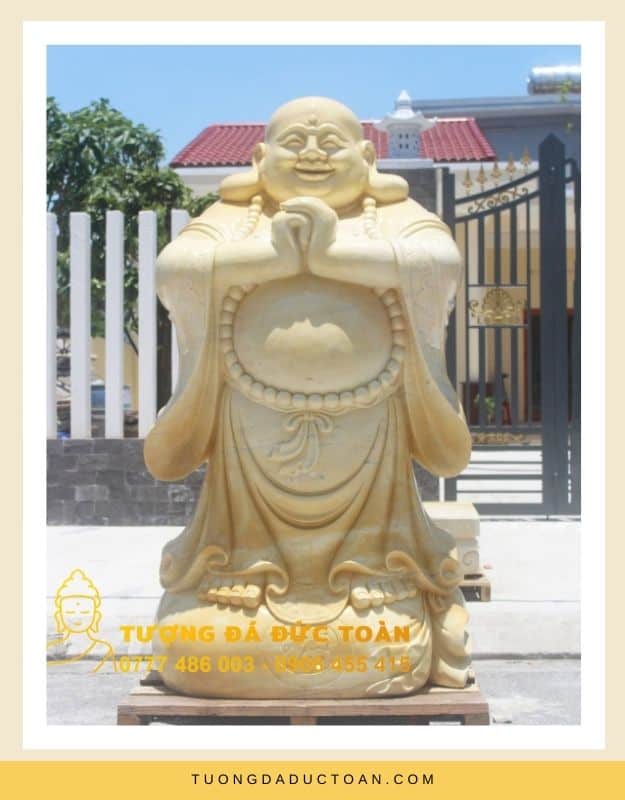 Tượng Phật Di Lặc chắp tay bằng đá màu vàng